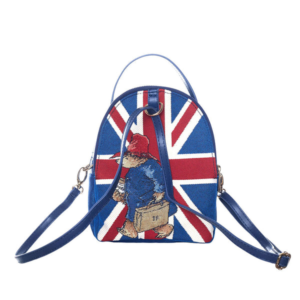 Paddington bear mini pack bag with the straps showing how big it can be. Blue bag with a Union Jack on the front and Paddington with a briefcase.