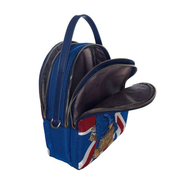 Paddington bear mini pack bag with the zips open so you can see inside the bag—Blue, with a union jack on the front and Paddington with a briefcase.