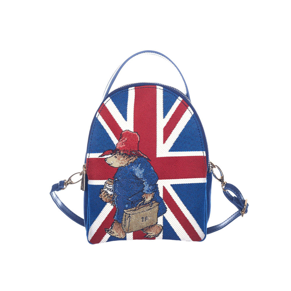 Paddington bear mini pack bag with the straps showing how big it can be. Blue bag with a Union Jack on the front and Paddington with a briefcase.